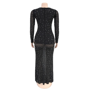 Close-up back view of black slim fit dress with sparkling rhinestones and floor-length hem