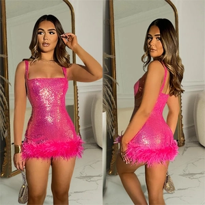 Detail of hot pink sequin mini dress featuring thin straps and elegant feather hemline