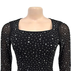 Detail of silver rhinestones on black mesh sleeves and square neck elegant dress