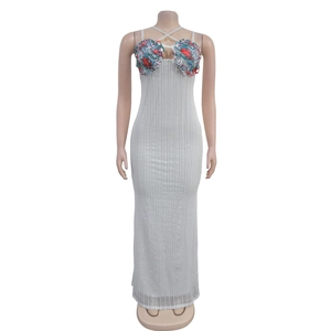 Detail of white ribbed knit fabric and floral pattern patchwork on a strap dress