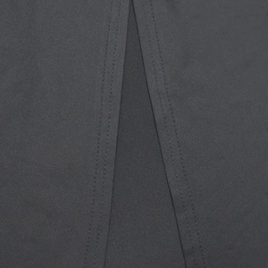 Macro shot of durable double-needle reinforced stitching on dark grey fabric garment