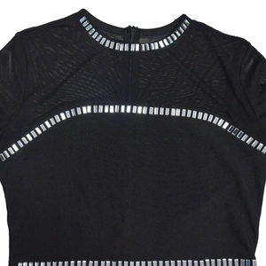 Detailed view of black mesh patchwork dress featuring silver sequins and a back zipper