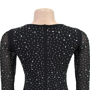 Detail of black rhinestone dress featuring mesh sleeves and back invisible zipper
