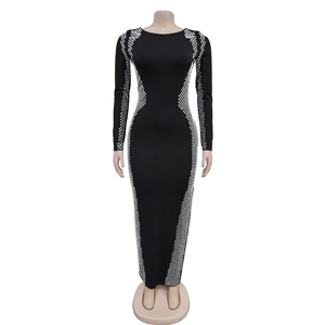 Detail view of silver rhinestone accents on side waist of slim black long sleeve dress