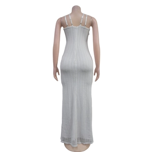 Detail of white knitted maxi dress back showing fine vertical texture and invisible zipper