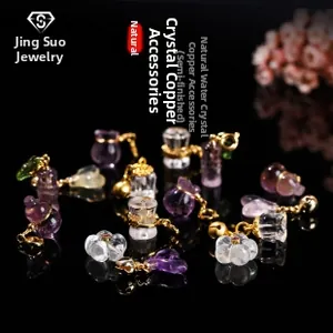 Macro shot of natural crystal pendants with gold-plated copper charms for jewelry making