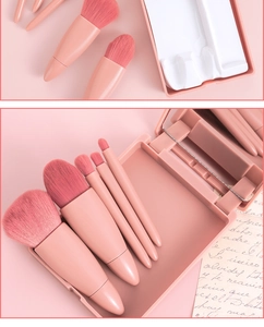 Close-up of portable makeup brush set in dusty pink case with mirror and five tools