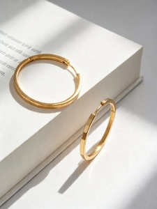 Detailed view of S925 silver gold-plated hoop earrings with geometric faceted textures