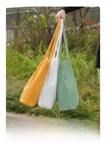 Three corduroy tote bags in yellow, beige and green colors for daily shopping and travel