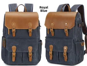 Vintage royal blue canvas camera backpack with brown leather trim and double buckles