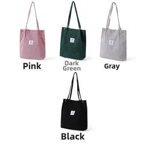 Corduroy tote bags in pink, dark green, gray, and black colors displayed on white background
