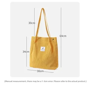 Detailed view of yellow corduroy tote bag showing dimensions 30x34cm with soft texture