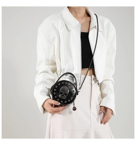 Mini round black crossbody bag featuring skull motif and silver stud trim details