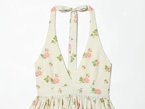 Detail of floral halter dress featuring a deep V-neck and ruffled bust in light green