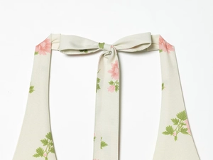 Detail of floral halter dress showing the elegant bow tie neck and back design