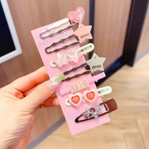 Vue détaillée du lot de 7 pinces à cheveux roses avec formes de cœur et d'étoile