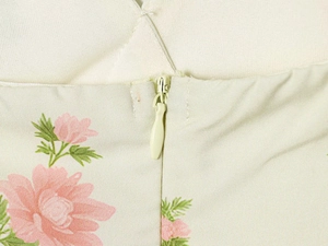 Macro shot showing invisible zipper closure and floral print on women summer dress