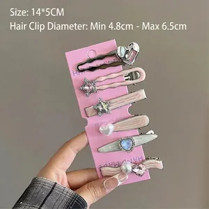 Détail lot de 6 pinces à cheveux avec cœurs et étoiles sur carte de 14x5cm