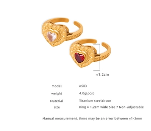 Vue macro de bagues en cœur en acier titane avec détails de zircons roses et rouges