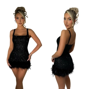 Detail of black sequined mini dress featuring lush feather hem and sleek spaghetti straps
