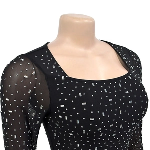 Detail of black mesh long sleeve dress with sparkling silver rhinestones and square neck