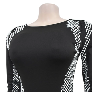 Close-up of black bodycon dress with silver geometric rhinestone pattern on shoulders