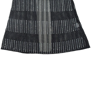 Macro shot of vertical striped fabric with sparkling silver rhinestones on black dress