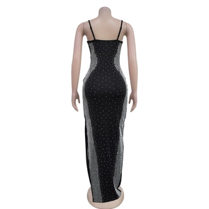 Macro detail of the deep open back and silver rhinestone mesh on a black party dress