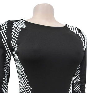 Close-up of geometric silver sequin embellishments on shoulders of a black dress