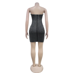 Detail view of the back zipper on a black bodycon dress with silver rhinestone embellishments
