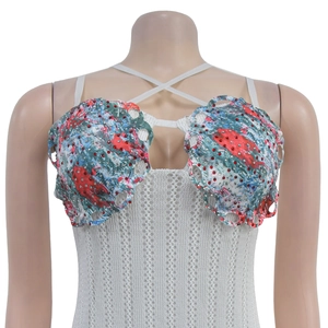 Detail showing white crochet dress with colorful shell cups and rhinestone embellishments