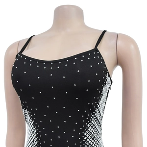 Detailed view of silver rhinestones and side geometric pattern on a black dress