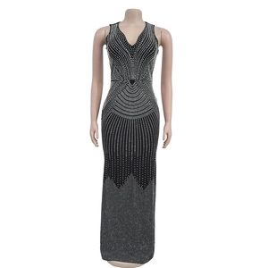Close-up of sparkling silver rhinestone geometric patterns on a black sleeveless V-neck maxi dress