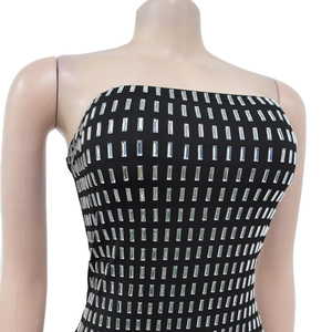 Detailed view of black rhinestones and silver rectangular sequins on a backless dress