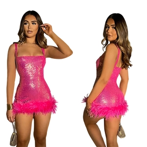 Detail of hot pink sequin mini dress with spaghetti straps and fluffy feather hemline
