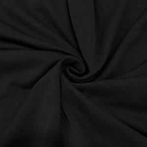 Detailed macro view of black elastic knit fabric texture and soft drape quality