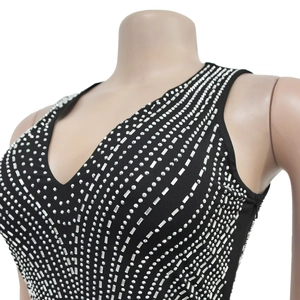 Close-up of sleeveless black dress featuring radiant silver rhinestone geometric patterns