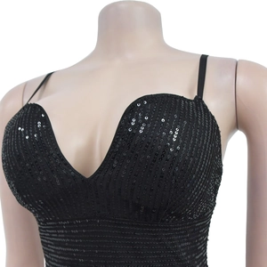 Detailed view of women's black sequin dress with deep V-neck and thin shoulder straps