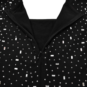 Macro detail of black dress fabric with sparkling silver rhinestones and invisible zipper