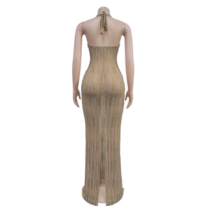Detail of a nude backless maxi dress with golden rhinestones and a back slit