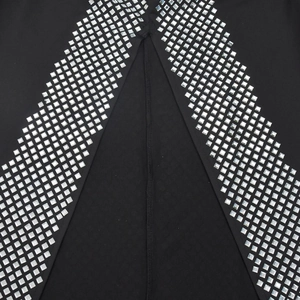 Detail of silver rhinestone V-pattern and stitching on black long sleeve dress fabric