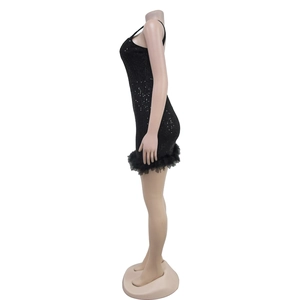 Close-up of black sequin bodycon dress with faux feather trim on the hemline