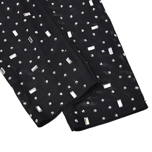Detail of black mesh fabric with silver rhinestones and rectangular crystal embellishments