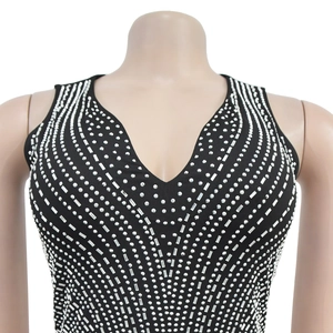 Detail of a black sleeveless top with deep V-neck and radiant silver rhinestone patterns