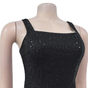 Detail of black sequined dress with square neckline and shimmering linear patterns