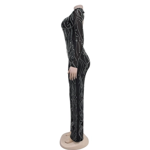 Detail of slim-fit black bodysuit with silver rhinestones in a streamlined pattern