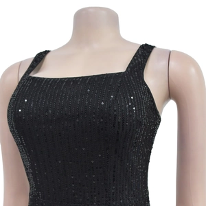 Detail of black sequined party dress featuring vertical sequins and wide shoulder straps