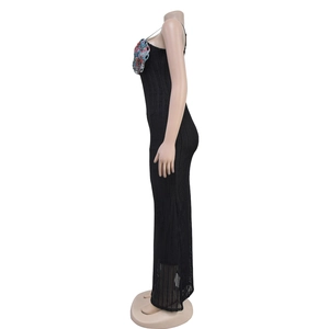 Side view of black knitted maxi dress featuring colorful butterfly sequin decorations