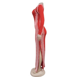 Detail of red long sleeve dress featuring white geometric pattern and side slit