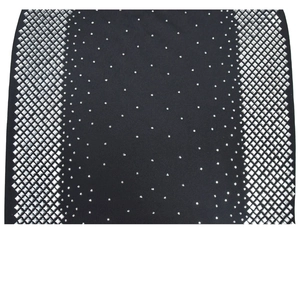Macro detail of sparkling silver square rhinestones and studs on black V-neck dress fabric